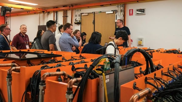 Delegates around DUG's orange computing racks